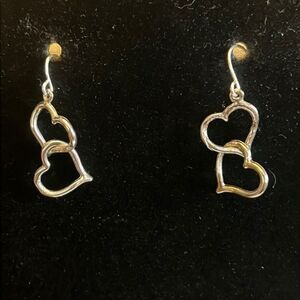 Handcrafted silver tone heart earrings.